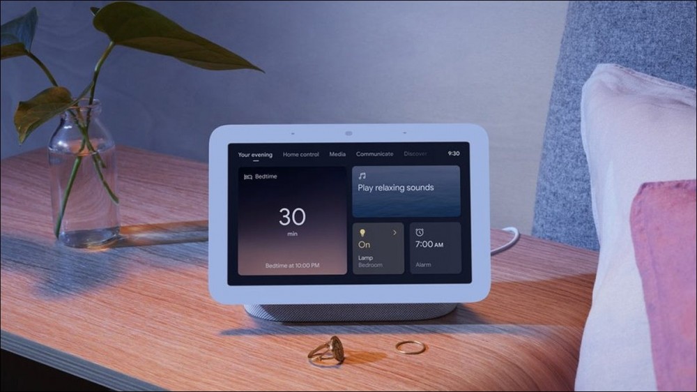 A Nest Hub on a nightstand, doing double duty as a Matter hub.