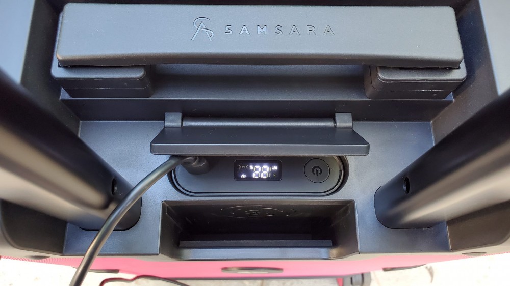 The T-Mobile Samsara Un-carrier On smart suitcase with the battery connected to a USB-C cable.